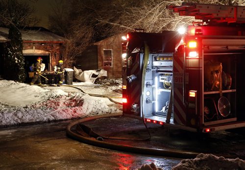 Winnipeg Fire Fighters on scene after a fire broke out in a storage tent beside the home at 19 Hiddleston Cres. shortly before 6a.m. Monday morning causing smoke and some fire damage between two homes. Occupants from both homes evacuated and no one was injured. Wayne Glowacki / Winnipeg Free Press Dec. 21  2015