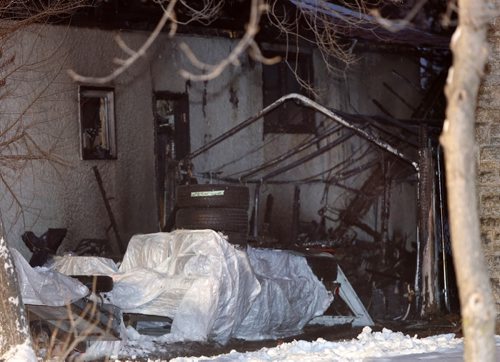 Fire broke out in a storage tent beside the home at 19 Hiddleston Cres. shortly before 6a.m. Monday morning causing smoke and some fire damage between two homes. Occupants from both homes evacuated and no one was injured. Wayne Glowacki / Winnipeg Free Press Dec. 21  2015