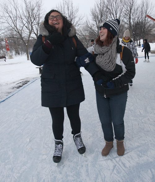 Forks Canopy Skating rink as part of Arctic Glacier Winter Park is now open today- Maria Zucco from Brazil, left,  gets some help skating for the first time by    Samantha Braun- Standup Photo- Dec 21, 2015    (JOE BRYKSA / WINNIPEG FREE PRESS)