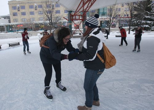 Forks Canopy Skating rink as part of Arctic Glacier Winter Park is now open today- Maria Zucco from Brazil, left,  gets some help skating for the first time by    Samantha Braun- Standup Photo- Dec 21, 2015    (JOE BRYKSA / WINNIPEG FREE PRESS)