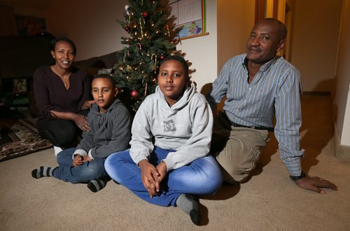 From left, Abiot Gorfu, sons Daniel (7) and Samuel (12) and husband Wassie came to Canada in June as refugees after fleeing Ethiopia. Photographed at their Assiniboia apartment on Dec. 21, 2015. Photo by Jason Halstead/Winnipeg Free Press RE: Family portrait for Year of the Refugee