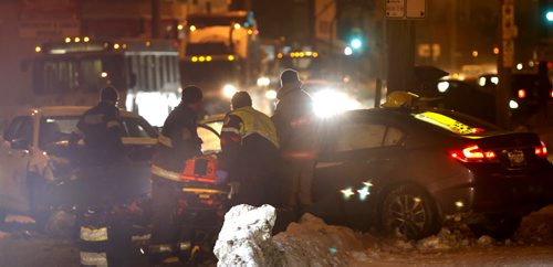 Winnipeg Fire Paramedics at the scene of a motor vehicle crash on Logan Ave. near Lizzie St. Tuesday morning. At least one was sent to the hospital. Wayne Glowacki / Winnipeg Free Press Dec. 22  2015
