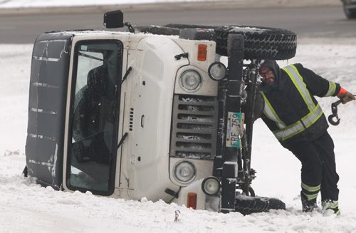 Tow crews hook up Jeep that flipped on Hyw 101 south of Hyw 06 Tuesday morning- Warmer temperatures have made the hyw wet and slick- Breaking News- Dec 22, 2015    (JOE BRYKSA / WINNIPEG FREE PRESS)