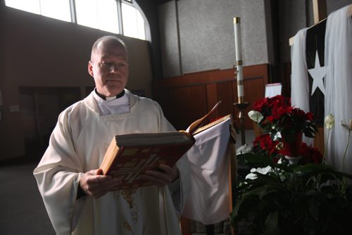 Christmas Front: Parish - St. Paul the Apostle, Father Eric Giddens  Father Giddens prepares for his Christmas message to his parishoners on making room in their lives for the new Syrian family the church is sponsoring that will arrive in early in new year. See Paul Wiecek's story Dec 22, 2015 Ruth Bonneville / Winnipeg Free Press