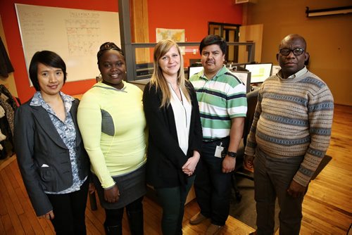 Jessica Praznik (centre) and three other Pre-Arrival Centre (PAC) facilitators, Elvi Tanghal (left), Diane Ingabire (second from left), and Abu Dukuly (right) along with PAC manager, Julio Lopez (second from right) will be Skyping in French and English with immigrants and refugees in the process of coming to Canada and Manitoba specifically to get them the right info they need to be ready to hit the ground running when they arrive. Jessica tests the software in preparation for a meeting with a client at the Immigrant Centre in Winnipeg's downtown.  151222 December 22, 2015 MIKE DEAL / WINNIPEG FREE PRESS