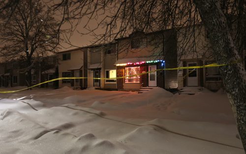 Police tape in front of houses Wednesday morning in the 1100 block of Beauty Ave. in the Maples. Wayne Glowacki / Winnipeg Free Press Dec. 23  2015