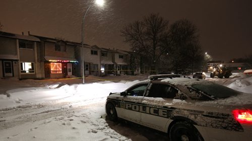 Winnipeg Police in front of taped off houses Wednesday morning in the 1100 block of Beauty Ave. in the Maples. Wayne Glowacki / Winnipeg Free Press Dec. 23  2015