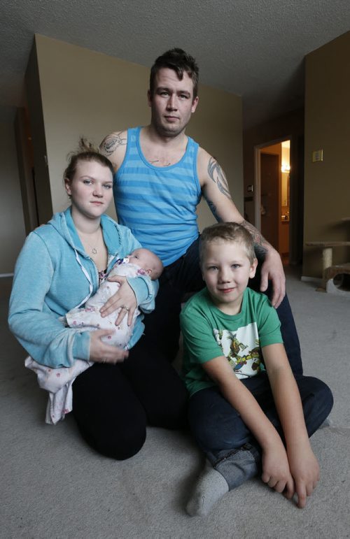 Crystal Freeman holds daughter Leah, 4mos. with stepson Keagin, 7 and husband Daimon Freeman have been fleeced for $1,300 in a condo rental scam and is now scrambling to find a place to live. Ashley Prest story Wayne Glowacki / Winnipeg Free Press Dec. 23  2015