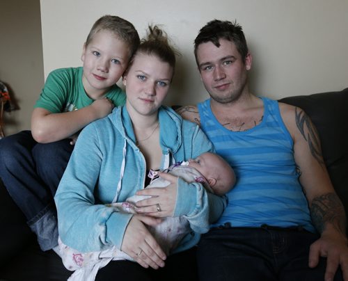 Crystal Freeman holds daughter Leah, 4mos. with stepson Keagin, 7 and husband Daimon Freeman have  been fleeced for $1,300 in a condo rental scam and is now scrambling to find a place to live. Ashley Prest story Wayne Glowacki / Winnipeg Free Press Dec. 23  2015