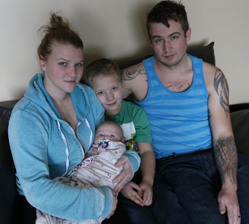 Crystal Freeman holds daughter Leah, 4mos. with stepson Keagin, 7 and husband Daimon Freeman have  been fleeced for $1,300 in a condo rental scam and is now scrambling to find a place to live. Ashley Prest story Wayne Glowacki / Winnipeg Free Press Dec. 23  2015