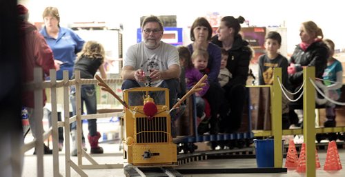 Gino Kost gdrives the "Holiday Express, an indoor train owned by Maurice and Susan Dorge around the former Safeway on Ness near Sturgeon.  See story....December 23, 2015 - (Phil Hossack / Winnipeg Free Press)