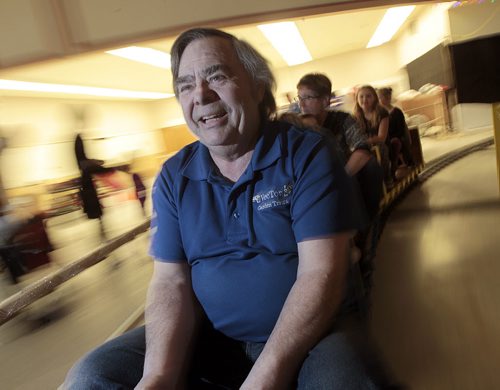 Maurice Dorge pilots his "Holiday Express, an indoor train around the former Safeway on Ness near Sturgeon.  See story....December 23, 2015 - (Phil Hossack / Winnipeg Free Press)  NOTE SEE PREVIOUS PHOTOS OF MAURICE AND HIS WIFE SUSAN ON THE TRAIN THAT HAVE NOT BEEN USED.