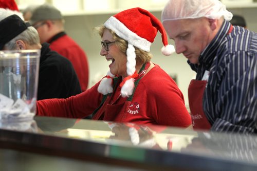 Carole Chocker is all smiles as she volunteers serving meals in the kitchen at Siloam Mission Thursday. See story on Siloam.    Dec 24, 2015 Ruth Bonneville / Winnipeg Free Press