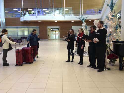 (l-r)Colleen Furlan, Amanda Stegmaier, Chad Abrahamson and Jay Janzen.   Travellers got a warm welcome at the Winnipeg airport today with carollers from the University of Manitoba Singers serenading them as they arrived and greeted friends and family members.  December 24/2015 Leah Hansen/Winnipeg Free Press