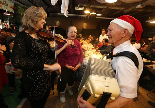 L-R: Daria Watkin, singer Linda Gora and Bjarne Aasland, perform for diners at the 10th annual Sons of Italy Christmas Eve Feast at X-Cues Billiards and Café on Dec. 24, 2015. Partners for the event included X-Cues, Sorrentos on Ellice and the West End BIZ. About 600 people were fed at the feast and 225 food hampers were distributed, as were gifts for about 250 children. Photo by Jason Halstead/Winnipeg Free Press RE: Social Page