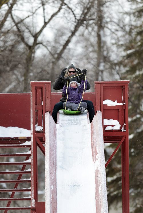 Frederic Boutin and his daughter Julietee (7) brace for the ride down the toboggan slide enjoying a frosty Christmas morning in Kildonan Park.The Boutin family are visiting the kids grandparents in the city while back at their Toronto home golfers are enjoying +15C WEATHER. December 25, 2015 - (Phil Hossack / Winnipeg Free Press)
