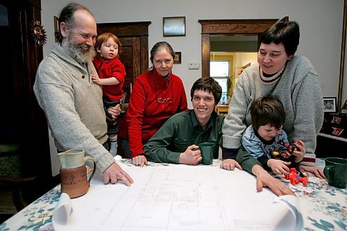BORIS MINKEVICH / WINNIPEG FREE PRESS  080131 Dave Hill, left holding grandchild, and his wife Barb Remnant, left of Hill wearing red, pose for a photo with their son and his family while looking at plans of their new multi-generational house they are building. (EDS-I have the other names and will get them in asap(sheet left in car 28)