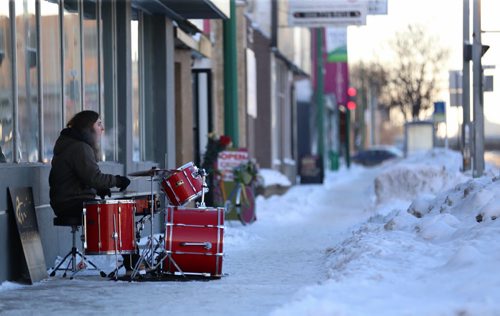 Shane Barron playing the drums on the sidewalk outside Quest Musique on Portage Avenue near Stiles Street, Saturday, December 26, 2015. (TREVOR HAGAN / WINNIPEG FREE PRESS)