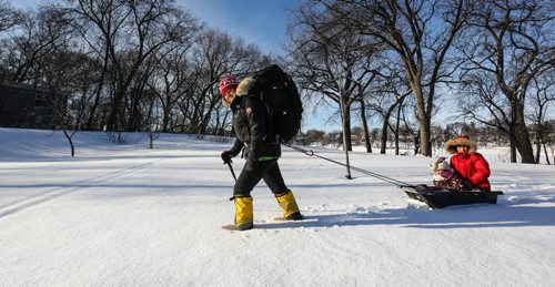 Sarah Dentry-Travis, a U of M researcher will be travelling to Antarctica in a few days with some war veterans. She will be hiking with them and studying the effects of stress on their bodies and minds. Sarah has been training for the extreme conditions she will face in Antartica and was out on Sunday with a full pack and a sled filled with her two children at Fraser's Grove Park.  151227 - Sunday, December 27, 2015 -  MIKE DEAL / WINNIPEG FREE PRESS