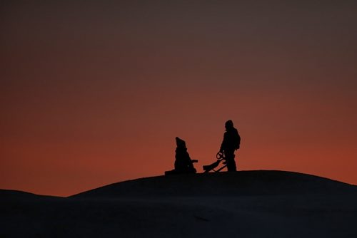 December 27, 2015 - 151227  -  A sunset sets the background for sliders on Westview Park hill Sunday, December 27, 2015.  John Woods / Winnipeg Free Press