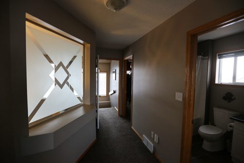 Homes Resale 113 Wayfarers Haven Frosted window in the master bedroom that looks over the living room. En-suite bathroom on the right and a walk-in closet in the background on the right. 151228 - Monday, December 28, 2015 -  MIKE DEAL / WINNIPEG FREE PRESS