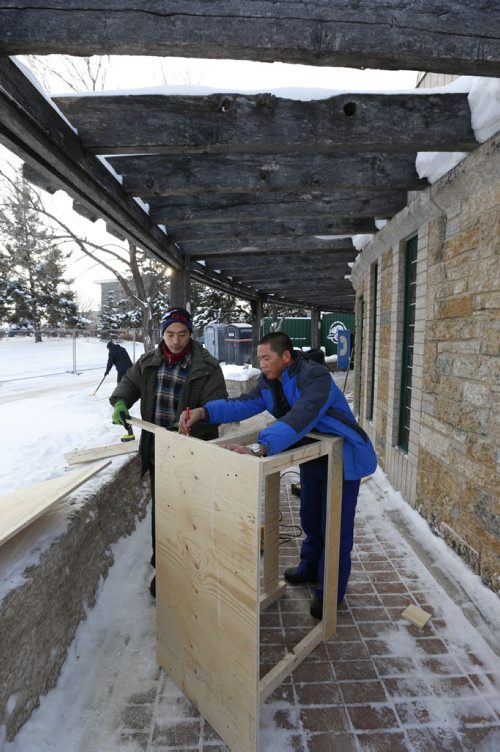 First things First.  Yuhe Zhang,right, and Yuzhu Ma two of the specially trained team of Chinese ice artisans in Winnipeg to create The Great Ice Show at The Forks. On Tuesday the pair built a table for their tools, the first ice blocks are expect to arrive from Birds Hill on Wednesday.   Story by Danielle Doiron Wayne Glowacki / Winnipeg Free Press Dec. 29  2015