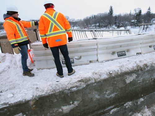 City crews inspect damage on Moray St bridge after a recent mva that send a vehicle crashing over the guard concrete and into the outside saftey rail See Carol Sanders story- Dec 30, 2015   (JOE BRYKSA / WINNIPEG FREE PRESS)