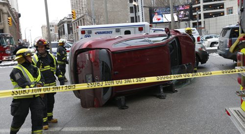 Winnipeg Fire Paramedics on scene of a collision on Portage Ave. at Fort St. Wednesday afternoon. The driver of the overturned vehicle was extricated through the front window and taken to the hospital. The crash closed Portage Ave. eastbound lanes.Wayne Glowacki / Winnipeg Free Press Dec. 30  2015