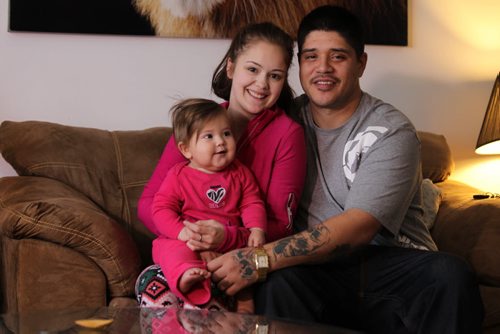 Photo of Darcy Vaughan who took training at BUILD (social enterprise centre) then went on to do his apprenticeship in carpentry and has turned his life completely around.  Pix of him with his girlfriend, Jenna-May Maynes, and his 10 month-old baby girl, Delilah.   See Carol Sanders story.  Dec 30, 2015 Ruth Bonneville / Winnipeg Free Press