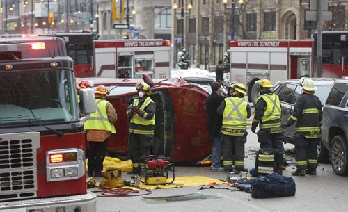 Winnipeg Fire Paramedics on scene of a collision on Portage Ave. at Fort St. Wednesday afternoon. The driver of the overturned vehicle was extricated through the front window and taken to the hospital. The crash closed Portage Ave. eastbound lanes.Wayne Glowacki / Winnipeg Free Press Dec. 30  2015