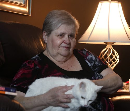 Penny Treflin at home with her cat Gizmo. When the provinces adoption records were opened up earlier this year, she didnt get as much useful info as she had hoped. But a couple of weeks ago, out of the blue, her birth family found her. Larry Kusch story. Wayne Glowacki / Winnipeg Free Press Dec. 30  2015