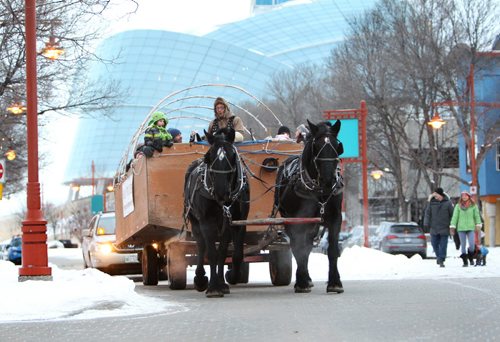 A Horse-drawn Hay-Ride full of passengers makes its way around the Forks grounds as part of the family fun activities taking place at the Forks Thursday for  New Years Eve. Standup   Dec 31, 2015 Ruth Bonneville / Winnipeg Free Press