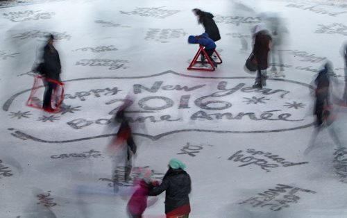 People move and spin on the ice under the canopy at the Forks Thursday with  "Happy New Year 2016" etched under the ice for New Years Eve celebrations.  Standup   Dec 31, 2015 Ruth Bonneville / Winnipeg Free Press