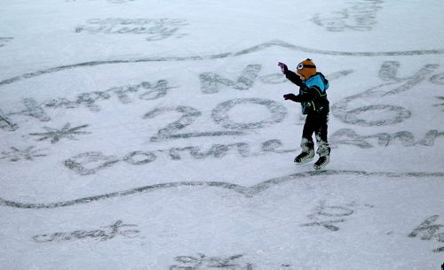 A child raises their arms to keep their balance as they skate under the canopy on the ice at the Forks Thursday hat has "Happy New Year 2016" written in the ice for New Years Eve celebrations.  Standup   Dec 31, 2015 Ruth Bonneville / Winnipeg Free Press