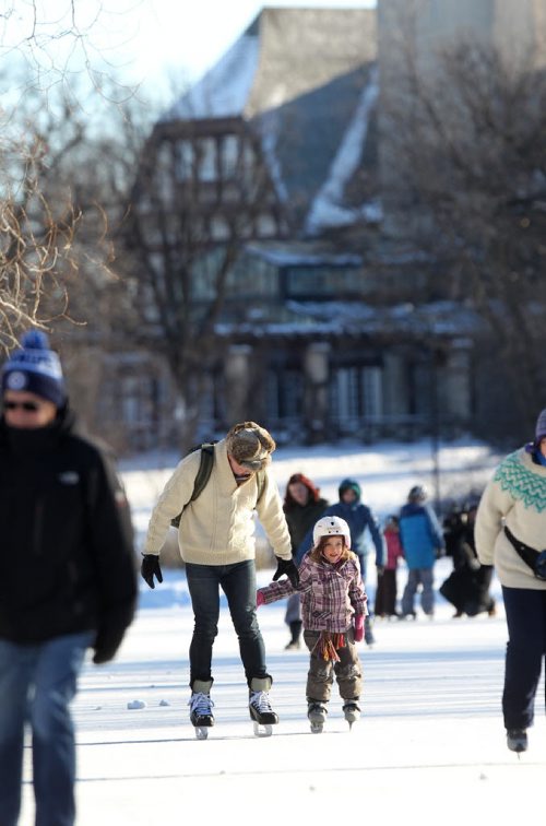 Families enjoy the balmy New Year's Day weather skating together on the Duck Pond at Assiniboine Park Friday. Standup  Jan 01, 2016 Ruth Bonneville / Winnipeg Free Press