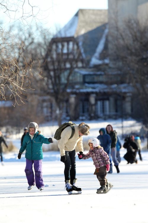 Families enjoy the balmy New Year's Day weather skating together on the Duck Pond at Assiniboine Park Friday. Standup  Jan 01, 2016 Ruth Bonneville / Winnipeg Free Press