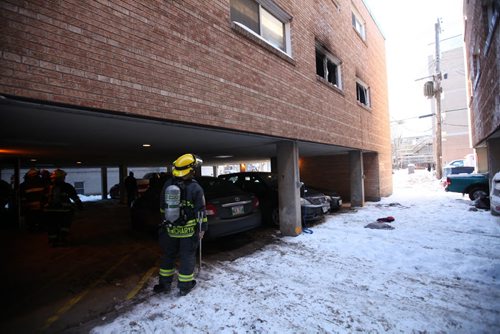 A member of the Fire Dept. up at the apartment window where a women jumped out of the 2nd storey after a fire broke out in her apartment at 188 Colony Street Friday afternoon.  Both the child and mother were treated on the scene. No further information at this time except that bystanders said they didn't see any serious injuries.   Jan 01, 2016 Ruth Bonneville / Winnipeg Free Press