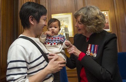 DAVID LIPNOWSKI / WINNIPEG FREE PRESS 160101  Lieutenant Governor Janice Filmon greets 7-month-old Bella Biscotto and her father Jose at the New Year's Levee at the Manitoba Legislature Building January 1, 2016.