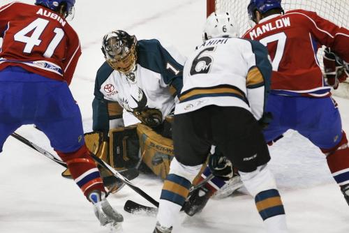 John Woods / Winnipeg Free Press / February 2, 2008- 080202  - Manitoba Moose Drew MacIntyre (1) stops the shot of Hamilton Bulldogs Eric Manlow (7) as teammate Mathieu Aubin (41) drives in for the rebound in first period AHL action in Winnipeg Saturday, February 2/08. Daniel Rahimi (6) of Manitoba helps defend their net.