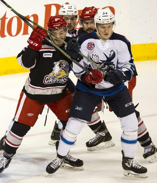 DAVID LIPNOWSKI / WINNIPEG FREE PRESS 160103  Manitoba Moose JC Lipon (#34) and Chase De Leo(#19) get tied up with Grand Rapids Griffins Robbie Russo (#5)  and Xavier Ouellet (#16) Sunday January 3, 2016 at MTS Centre.