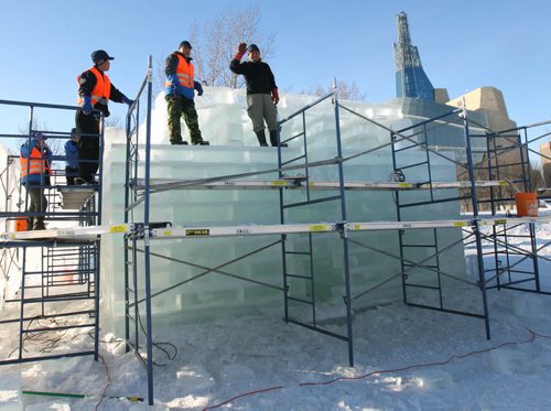 40 Artists from the Canadian Icetival Inc from Heilonjiang Province in Northern China are hard at work preparing their ice wonderland at the Forks Tuesday  The crew who live at about the same latitude in China as Winnipeg have been fighting the recent warm weather- In their hometown of Haerbin their ice festival brought 1.44 Billion dollars to their local economy from tourism-The display including a 40ft replica of the Manitoba Legislature will be open to the public from Jan 20-25, 2016- In this shot workers build Legislature replica- Standup Photo- Jan 05, 2016   (JOE BRYKSA / WINNIPEG FREE PRESS)