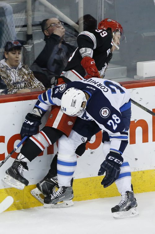 Manitoba Moose Patrice Cormier (28) checks Grand Rapids Griffins' Tyler Bertuzzi (39) during first period AHL action in Winnipeg on Tuesday, January 5, 2016. (John Woods / WINNIPEG FREE PRESS)