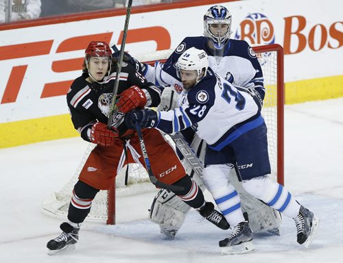 Manitoba Moose Patrice Cormier (28) moves Grand Rapids Griffins' Tyler Bertuzzi (39) from in front of goaltender Eric Comrie (1) during first period AHL action in Winnipeg on Tuesday, January 5, 2016. (John Woods / WINNIPEG FREE PRESS)
