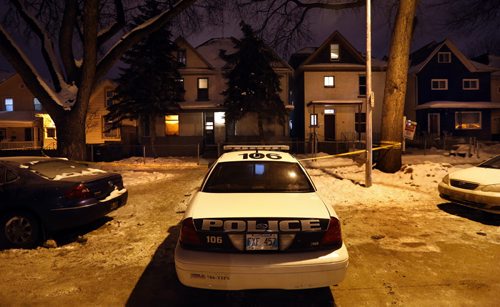 Winnipeg Police are parked outside a house Wednesday morning in the 500 block of Spence Street after a man was shot Tuesday evening.  Wayne Glowacki / Winnipeg Free Press Jan. 6 2016