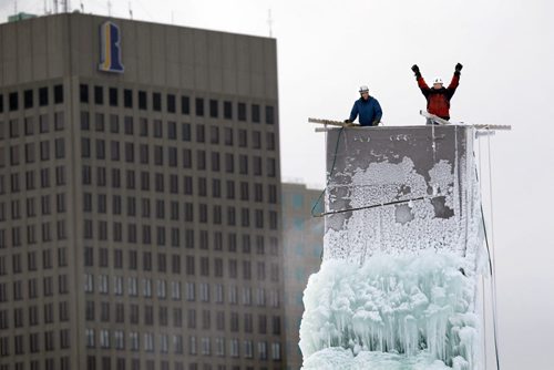 STANDUP - (L-R) Paul Hrynkow and André Mahé of Club d'escalade de Saint-Boniface adjust one of the three icing sticks used to build the ice climbing structure across the river from downtown Winnipeg. The tower is situated at 141 Messager St. in Saint-Boniface. Club President André Mahé says that the warm weather has delayed the building of the 60 foot ice tower but it will be open in a week or so. BORIS MINKEVICH / WINNIPEG FREE PRESS  January 6, 2016