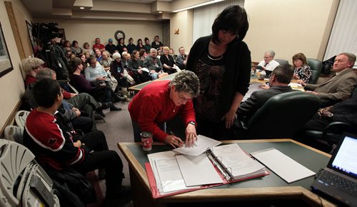 Presentors sign up in a packed chambers to speak at a Stonewall community counsel meeting considering a conditional use permit allowing a Community Living home in the town. The meeting started in town council chambers but was quickly moved to the United Church to accomodate the three hundred or so attendies. Ashley Prest story. . January 7, 2015 - (Phil Hossack / Winnipeg Free Press)