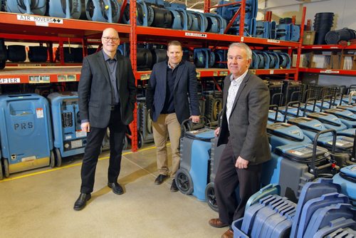 BIZ- Priority Restoration. left-right: VP Finance Richard Hutchings, VP general manager Scott Meyer,, and managing partner/president Ken Klassen pose for a photo in the warehouse where they store some restoration equipment used in the business. BORIS MINKEVICH / WINNIPEG FREE PRESS  January 7, 2016
