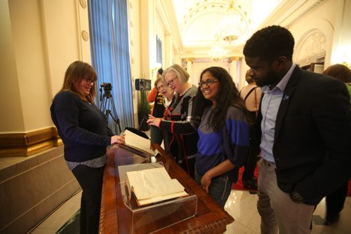 People look over the original Bill from 1916 amending women's right to vote at the 1st celebratory event  honouring the 100-year milestone in Manitoba womens electoral progress at the Legislative Building Friday.   Jan 08, 2016 Ruth Bonneville / Winnipeg Free Press