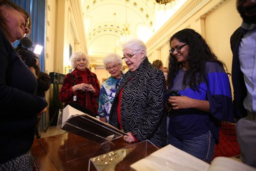 People look over the original Bill from 1916 amending women's right to vote at the 1st celebratory event  honouring the 100-year milestone in Manitoba womens electoral progress at the Legislative Building Friday.   Jan 08, 2016 Ruth Bonneville / Winnipeg Free Press