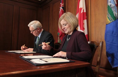Premier Greg Selinger and  Alberta Premier Rachel Notley sign documents on energy infrastructure, renewable energy and climate-change priorities at the Legislative Building Friday.   Jan 08, 2016 Ruth Bonneville / Winnipeg Free Press